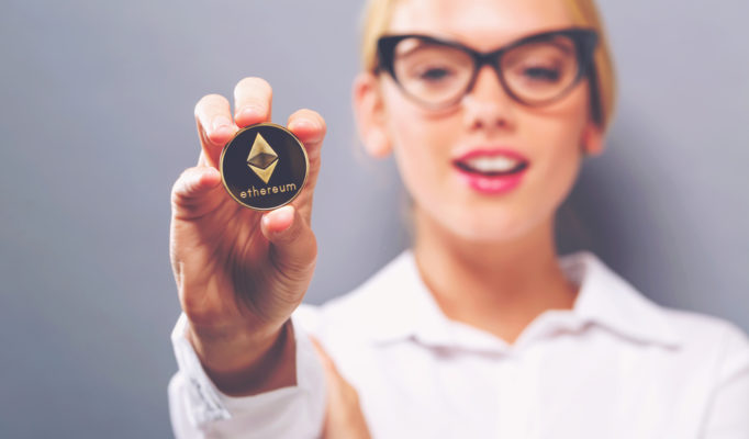 Woman,Holding,A,Physical,Ethereum,Coin,Cryptocurrency,In,Her,Hand