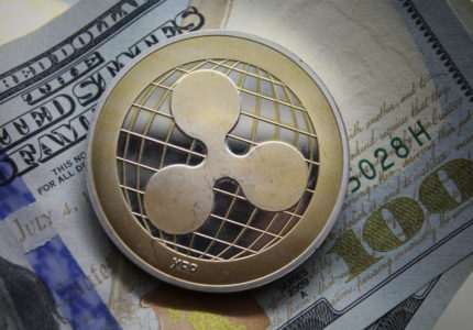 Ripple,Xrp,Golden,Cryptocurrency,Coin,Lying,On,A,Hundred,Dollars