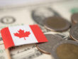 Canada,Flag,On,Coins,And,Banknotes,Background,,Finance,And,Accounting,
