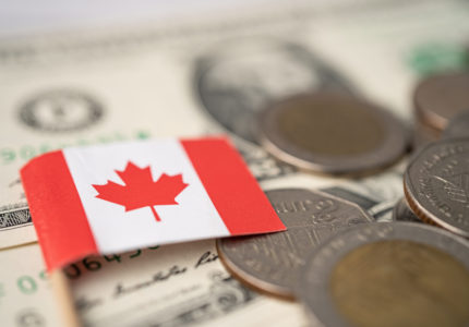 Canada,Flag,On,Coins,And,Banknotes,Background,,Finance,And,Accounting,