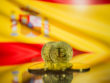 Bitcoin,Gold,Coin,And,Defocused,Flag,Of,Spain,Background.,Virtual