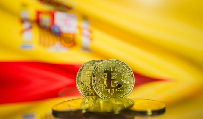 Bitcoin,Gold,Coin,And,Defocused,Flag,Of,Spain,Background.,Virtual